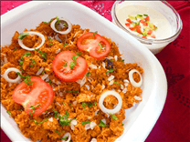 Tasty Chicken Biryani served with a Cucumber Raita (a cooling yogurt dip)